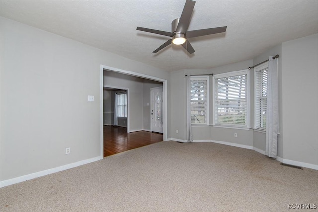 10710 Courthouse Rd, Dinwiddie, VA 23841 - unfurnished room featuring a textured ceiling, ceiling fan, and dark hardwood / wood-style floors