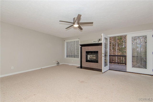 10710 Courthouse Rd, Dinwiddie, VA 23841 - unfurnished living room with a tiled fireplace, ceiling fan, light colored carpet, and a textured ceiling