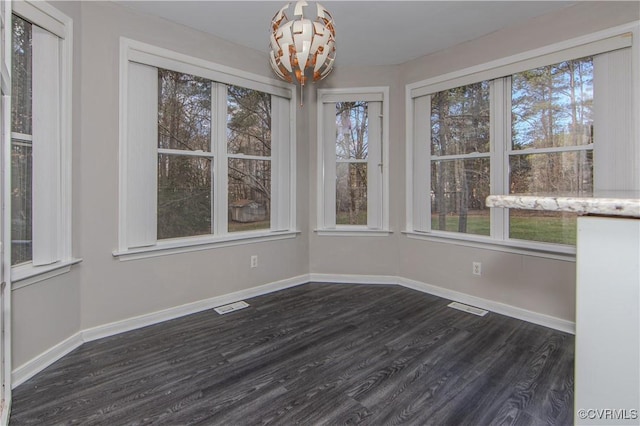 10710 Courthouse Rd, Dinwiddie, VA 23841 - unfurnished dining area featuring a chandelier, a wealth of natural light, and dark wood-type flooring