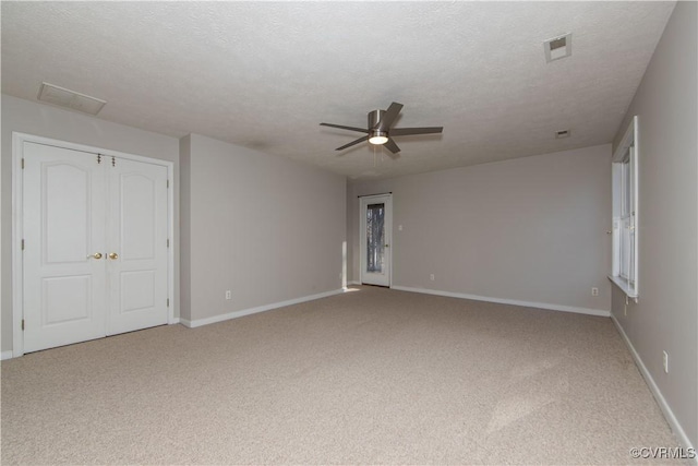 10710 Courthouse Rd, Dinwiddie, VA 23841 - unfurnished bedroom featuring ceiling fan, a closet, light carpet, and a textured ceiling