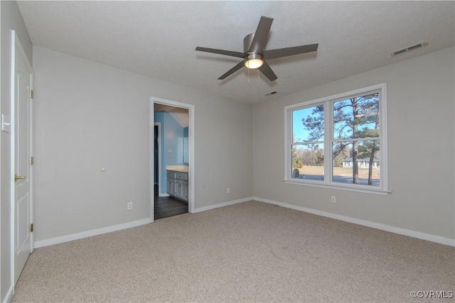 10710 Courthouse Rd, Dinwiddie, VA 23841 - unfurnished bedroom featuring carpet flooring, a textured ceiling, ensuite bath, and ceiling fan
