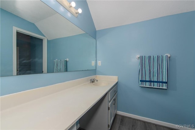 10710 Courthouse Rd, Dinwiddie, VA 23841 - bathroom with hardwood / wood-style flooring, vanity, and lofted ceiling