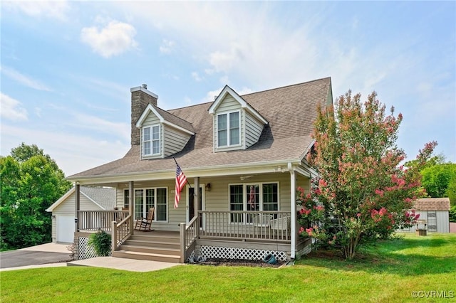 cape cod home featuring covered porch, a garage, a shed, and a front yard