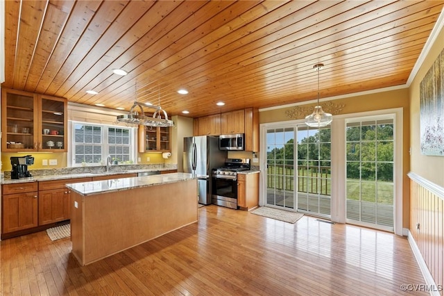 kitchen featuring appliances with stainless steel finishes, light hardwood / wood-style floors, a kitchen island, and wooden ceiling