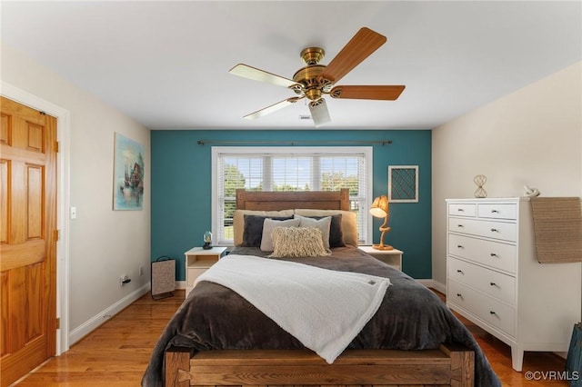 bedroom with light wood-type flooring and ceiling fan