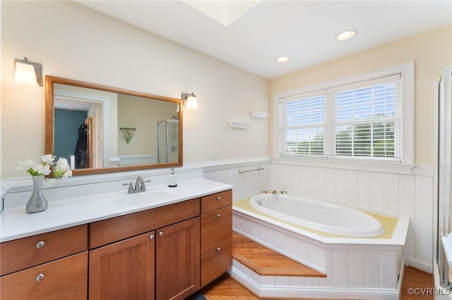 bathroom featuring vanity and separate shower and tub