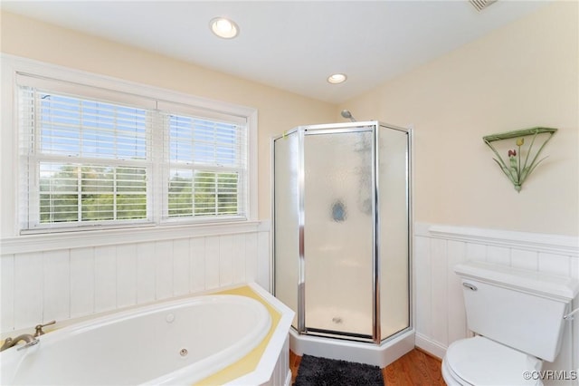 bathroom with hardwood / wood-style flooring, toilet, and independent shower and bath