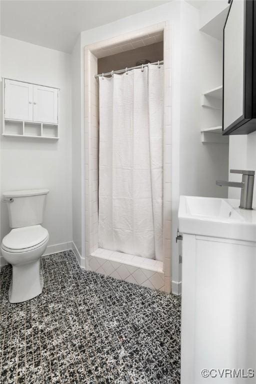 bathroom with vanity, toilet, and walk in shower