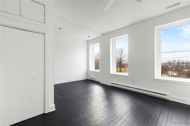 unfurnished bedroom featuring a baseboard radiator, dark hardwood / wood-style floors, and ceiling fan