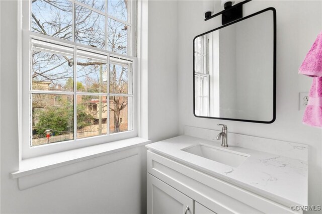 bathroom with plenty of natural light and vanity