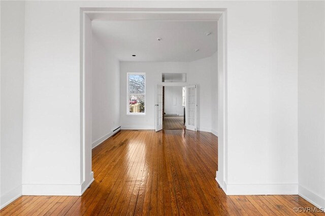 hallway featuring hardwood / wood-style flooring and baseboard heating