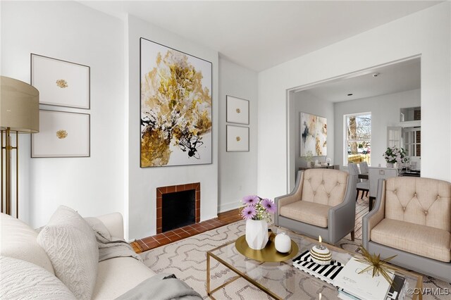 living room with a tile fireplace and hardwood / wood-style floors