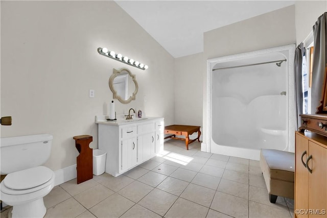 bathroom with tile patterned flooring, vanity, toilet, and lofted ceiling