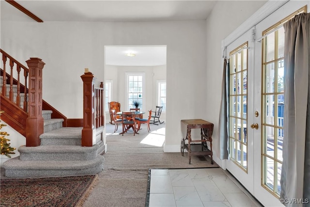 carpeted entryway with french doors