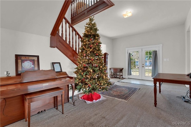 miscellaneous room featuring light carpet and french doors