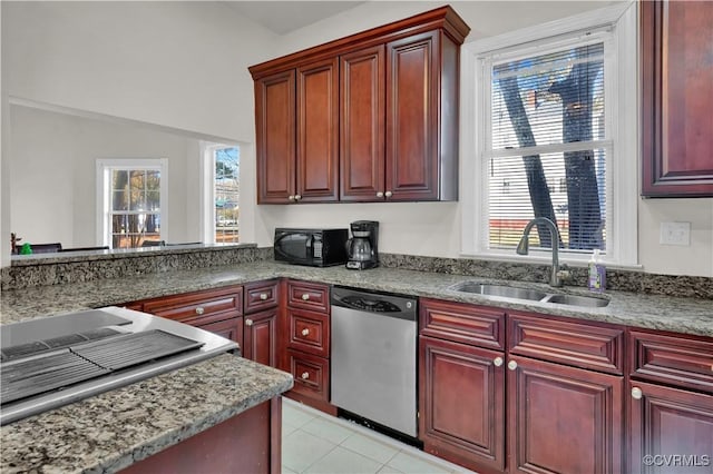 kitchen featuring light tile patterned flooring, stainless steel dishwasher, plenty of natural light, and sink