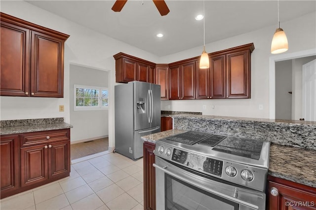 kitchen with stone counters, ceiling fan, pendant lighting, and appliances with stainless steel finishes