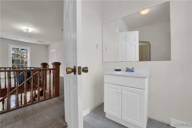 bathroom featuring tile patterned flooring and vanity