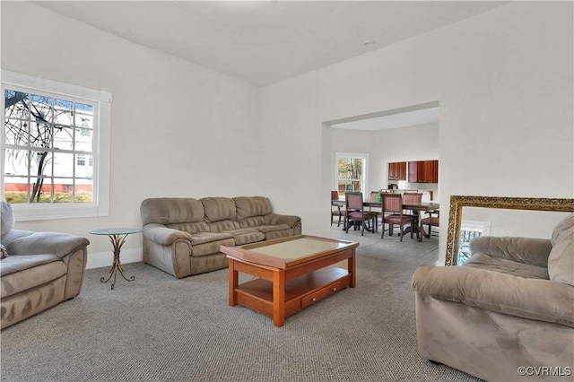 carpeted living room featuring plenty of natural light