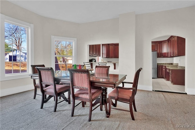 dining space featuring light colored carpet