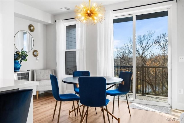 dining space featuring an inviting chandelier and wood-type flooring