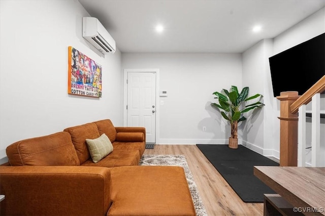 living room featuring hardwood / wood-style floors and a wall mounted AC