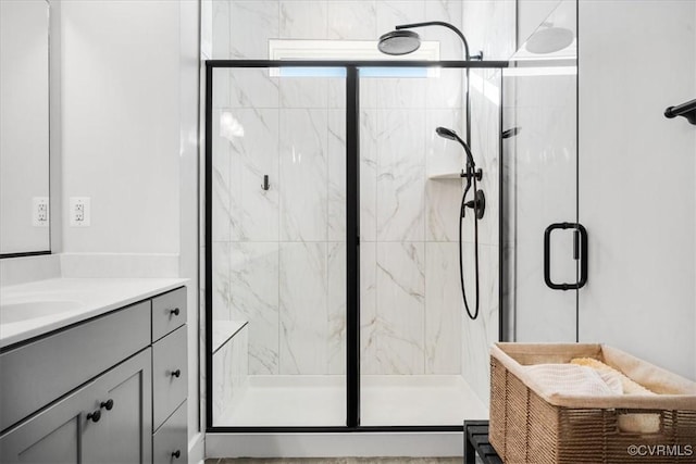 bathroom featuring vanity and a shower with shower door