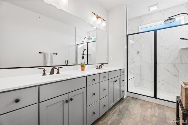 bathroom featuring an enclosed shower and vanity