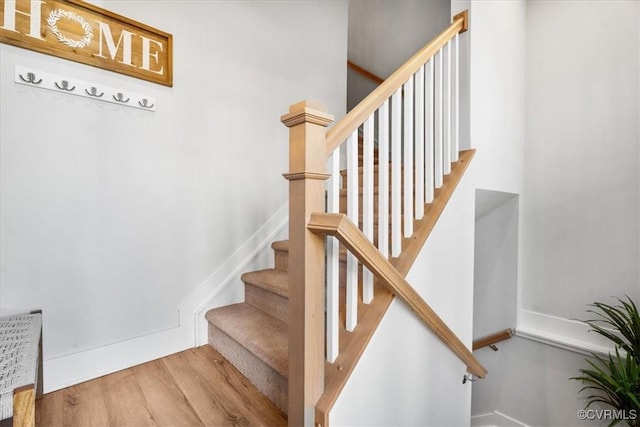 staircase with hardwood / wood-style floors