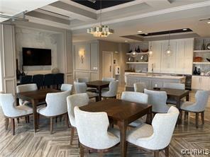 dining area featuring parquet floors, crown molding, and a chandelier