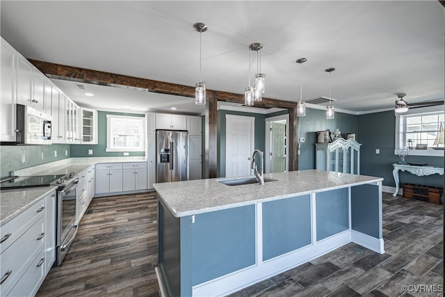 kitchen featuring a kitchen island with sink, sink, dark hardwood / wood-style floors, appliances with stainless steel finishes, and white cabinetry