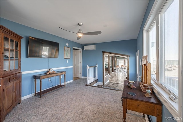 interior space featuring an AC wall unit, ceiling fan, and lofted ceiling