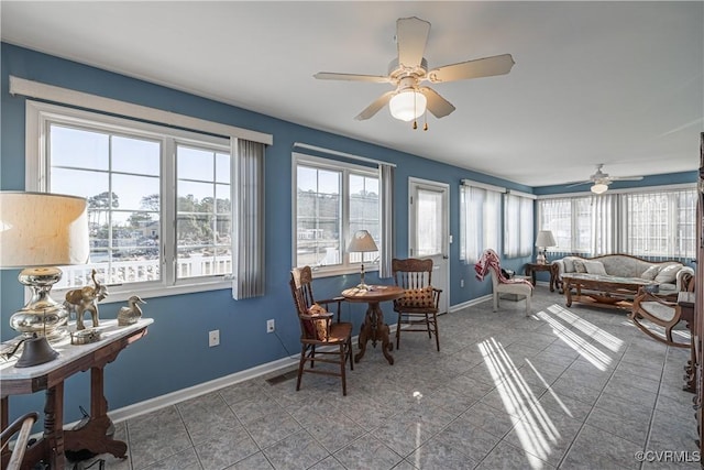 sunroom / solarium featuring ceiling fan and a wealth of natural light