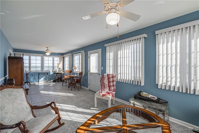 interior space with ceiling fan