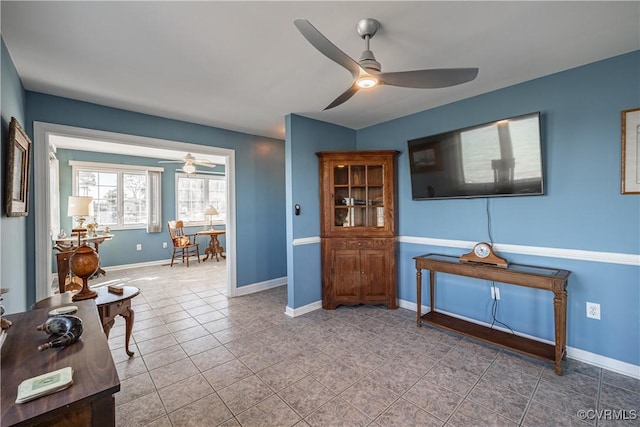 interior space with ceiling fan