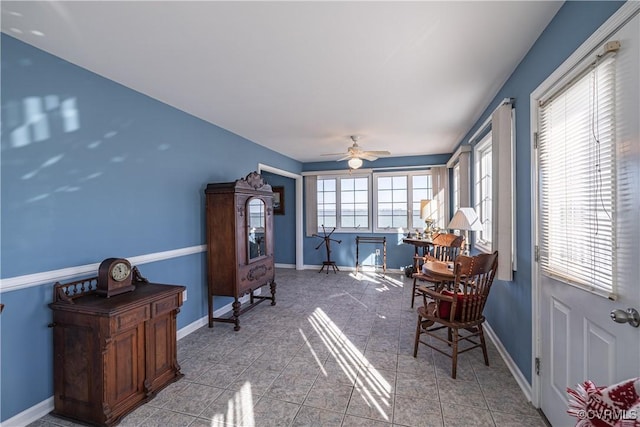 sunroom featuring ceiling fan and plenty of natural light