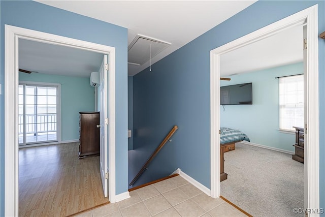 hall featuring an AC wall unit and light hardwood / wood-style floors