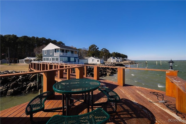 wooden terrace featuring a water view