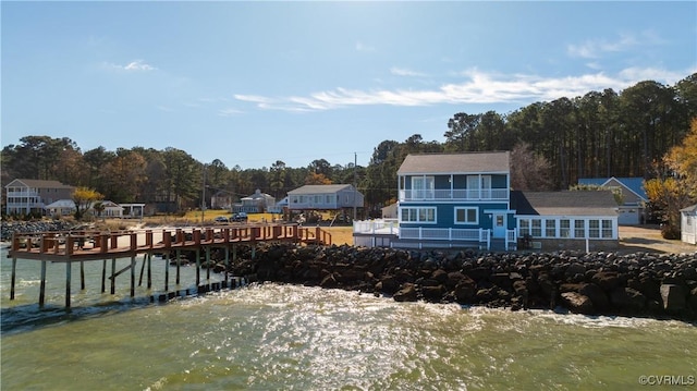 rear view of house featuring a water view