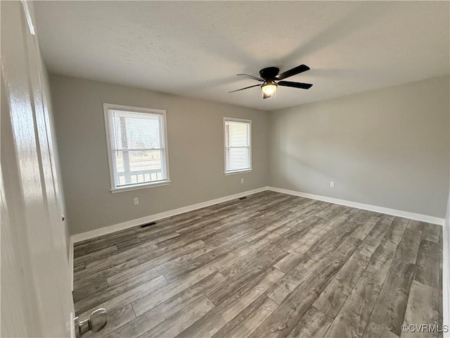 unfurnished room featuring a textured ceiling, wood-type flooring, and ceiling fan