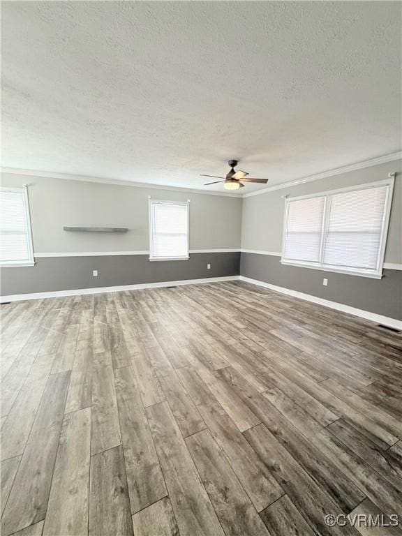 unfurnished living room with crown molding, ceiling fan, hardwood / wood-style floors, and a textured ceiling