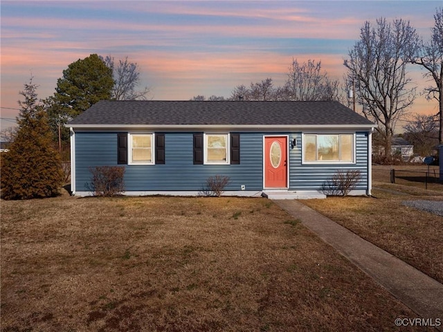 ranch-style home with a lawn