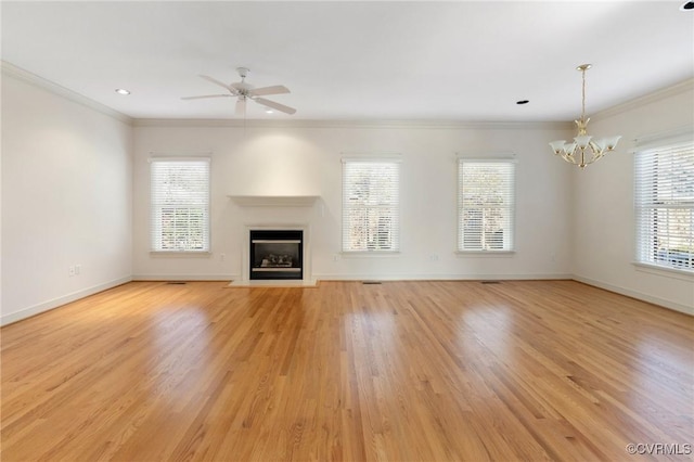 unfurnished living room featuring ornamental molding, ceiling fan with notable chandelier, and light wood-type flooring