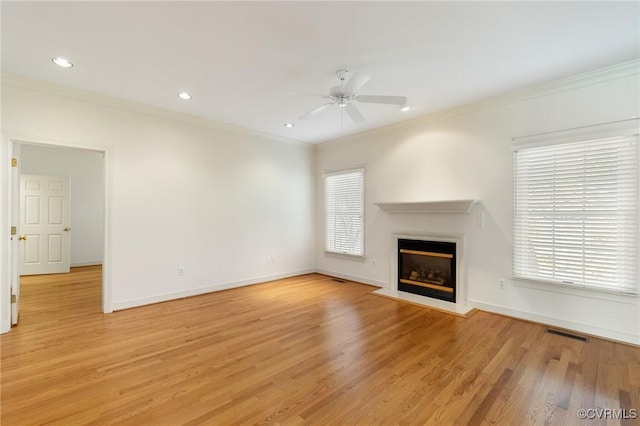 unfurnished living room featuring crown molding, ceiling fan, and light wood-type flooring