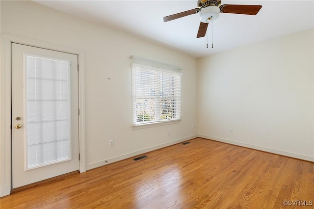 spare room with ceiling fan and light wood-type flooring