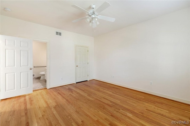 unfurnished bedroom with ceiling fan, light wood-type flooring, and ensuite bathroom