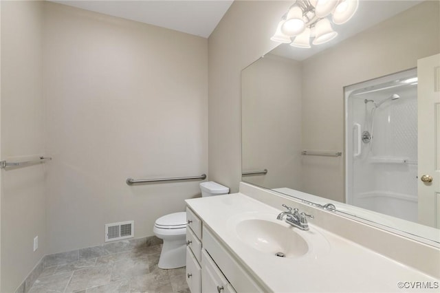 bathroom with vanity, toilet, and walk in shower