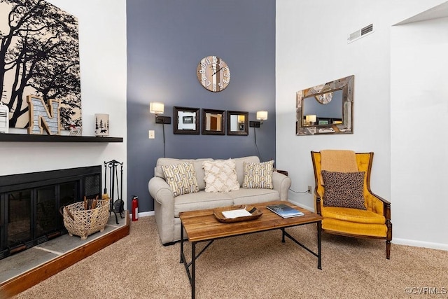 living room with carpet flooring and a high ceiling