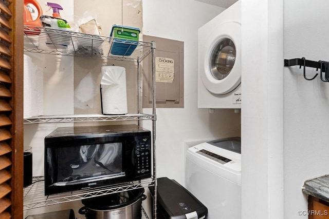 laundry room with stacked washer and dryer