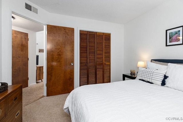 bedroom featuring light carpet and a closet